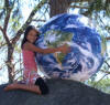 girld holding a large inflatable world globe