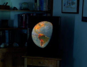 Illuminated earth globe in dark room