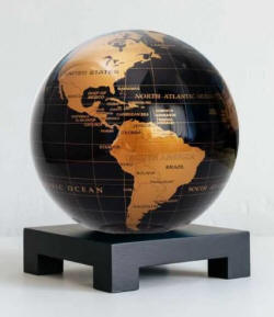 Black and gold self rotating world globe on wood base